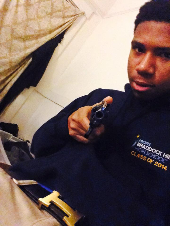 Shaquir Gilmore, in what is believed to be one of his Facebook profile pictures, posing with a gun. He was one of two students arrested this week for having a gun on school property. (Photo courtesy of Facebook)