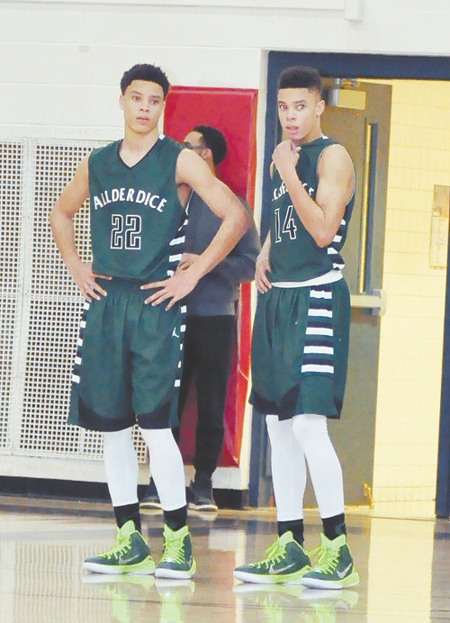 THE JACKSON TWINS—James, left, and Tim combined for 35 points, James had 21 and Tim scored 14 to lead the Allderdice Dragons to a 66-53 win over Obama Academy in a battle for first place in the City League. (Photos by William McBRide) 