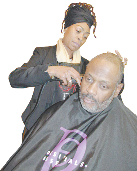 MEN ARE WELCOME—Ralph Watson of Classic Events experiences the expertise of Me’chele Humphries-Hayes as she grooms him for his February 28 Black History Month Celebration Dinner.