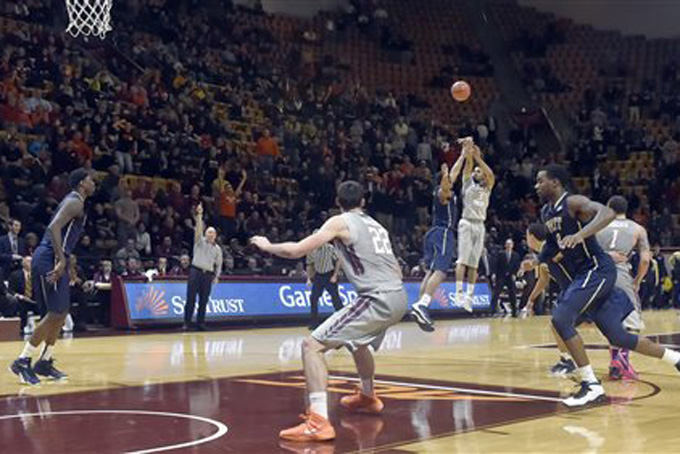Virginia Tech's Adam Smith (3) shoots the winning basket in overtime against Pittsburgh in an NCAA college basketball game Tuesday,  Jan. 27, 2015, in Blacksburg, Va. Virginia Tech won 70-67. (AP Photo/The Roanoke Times, Don Petersen)