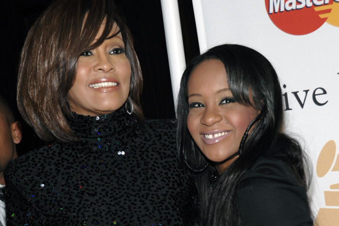 In this Feb. 12, 2011, file photo, singer Whitney Houston, left, and daughter Bobbi Kristina Brown arrive at an event in Beverly Hills, Calif. (AP Photo/Dan Steinberg, File)