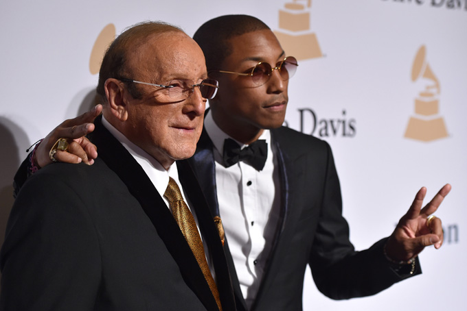 Clive Davis, left, and Pharrell Williams arrive at the 2015 Clive Davis Pre-Grammy Gala at the Beverly Hilton Hotel on Saturday, Feb. 7, 2015, in Beverly Hills, Calif. (Photo by John Shearer/Invision/AP