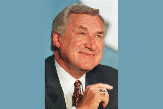 In an Oct. 9, 1997 file photo, North Carolina basketball coach Dean Smith smiles during a news conference in Chapel Hill, N.C.,where he announced his retirement. (AP File Photo)
