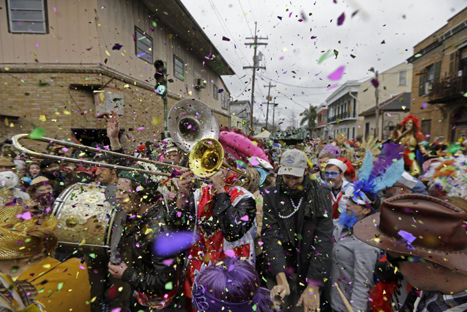 Revelers play brass band music as they begin the march of the Society of Saint Anne Mardi Gras parade, on Mardi Gras in New Orleans, Tuesday, Feb. 17, 2015. Revelers in glitzy costumes filled the streets of New Orleans for the annual fat Tuesday bash, opening a day of partying, parades and good-natured jostling for beads and trinkets tossed from passing floats. (AP Photo/Gerald Herbert)