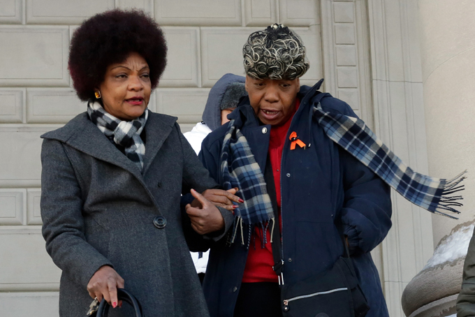 Gwen Carr, right, mother of chokehold death victim Eric Garner, is escorted by National Action Network's Staten Island President Cynthia Davis, after they attended a court hearing, in the Staten Island borough of New York, Thursday, Feb. 5, 2015.  (AP Photo/Richard Drew)