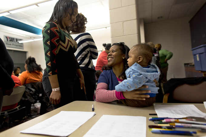 Volunteer Monet Williams, center, holds a friend's baby whose mother is participating in a monthly gathering that promotes breast-feeding, as she talks to another volunteer at a YMCA in Milwaukee. Breast-feeding is thought to help protect against higher rates of infant mortality and childhood obesity, to more breast cancer deaths and heart disease in adults - and it's much less common among U.S. black women than in whites and others. Rates have improved in recent years but the disparity remains. (AP Photo/Darren Hauck)