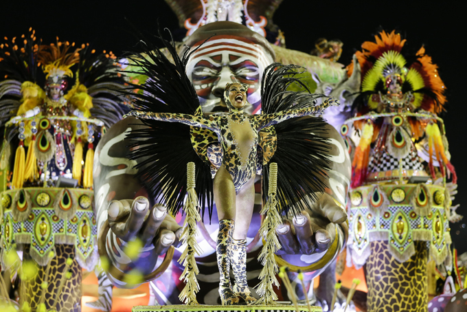 Performers from the Imperatriz Leopoldinense samba school parade on a float during carnival celebrations at the Sambadrome in Rio de Janeiro, Brazil, Tuesday, Feb. 17, 2015. (AP Photo/Felipe Dana)
