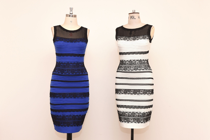 The two-tone dress, left, alongside an ivory and black version, made by Roman Originals, that has sparked a global debate on Twitter over what colour it is on display in Birmingham, England Friday, Feb. 27, 2015. It's the dress that's beating the Internet black and blue. Or should that be gold and white? Friends and co-workers worldwide are debating the true hues of a royal blue dress with black lace that, to many an eye, transforms in one photograph into gold and white. (AP Photo/PA. Joe Giddens) 