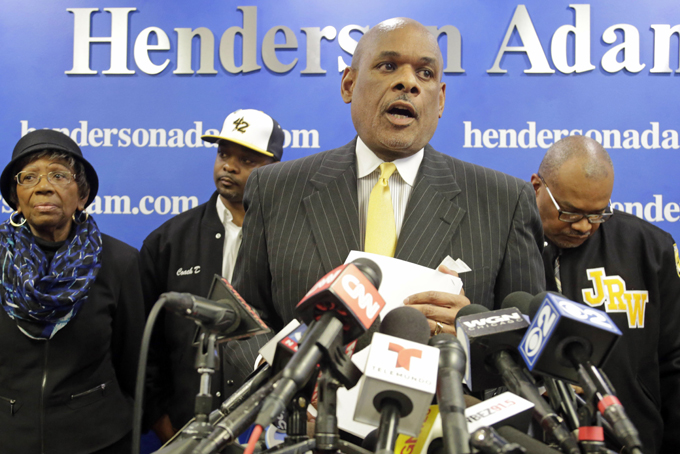 Attorney Victor P. Henderson, center, is joined from left by Anne Haley, president and co-founder of Jackie Robinson West Little League; Jackie Robinson West manager Darold Butler; and Bill Haley, director of Jackie Robinson West Little League, during a news conference, Thursday, Feb. 12, 2015, in Chicago. Henderson says he's working with local Little League officials to investigate the international governing body's decision to strip the Chicago team of its national title. (AP Photo/M. Spencer Green)