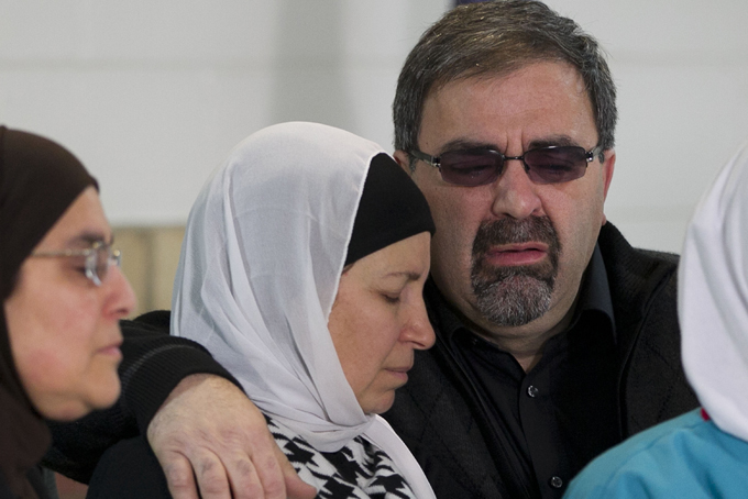 Namee Barakat, right, embraces his wife Layla Barakat during a news conference on Wednesday, Feb. 11, 2015, in Raleigh, N.C. They are the parents of Deah Shaddy Barakat, a doctoral student at UNC-Chapel Hill's School of Dentistry who was killed Tuesday in Chapel Hill, N.C., along with his wife Yusor Mohammad Abu-Salhaand her sister Razan Mohammad Abu-Salha. (AP Photo/The News & Observer, Robert Willett) 