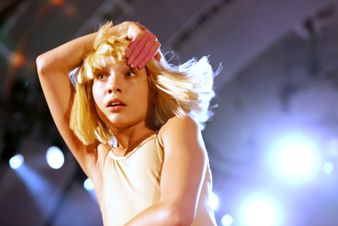 In this Oct. 24, 2014 file photo, Maddie Ziegler dances to Sia's performance at CBS Radio's second annual We Can Survive concert at the Hollywood Bowl in Los Angeles. The face for Sia’s music – the child dancer Ziegler who first gained fame as a star on the Lifetime series, “Dance Moms” – says singing could be in her future. (Photo by Todd Williamson/Invision/AP, File)