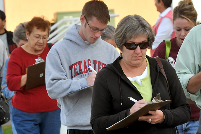 In this Oct. 10, 2009 file photo, people fill out forms to get a free seasonal flu shot at Memorial Medical Center in Las Cruces, N.M. Those seemingly harmless medical forms everyone fills out before seeing a doctor can plant the seeds for identity theft and other scams if they get into the wrong hands. (AP Photo/Las Cruces Sun-News, Norm Dettlaff, File)