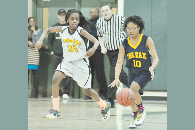 IMANI LOWE (24) of Sterrett and McKenzie Thompson (10) of Colfax go for a loose ball in the City League Middle School  championship.