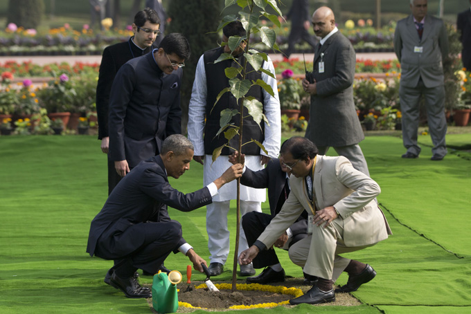 In this Sunday, Jan. 25, 2015 file photo, U.S. President Barack Obama, left, participates in a tree planting ceremony at the Raj Ghat Mahatma Gandhi Memorial, New Delhi, India. (AP Photo/Carolyn Kaster, File)
