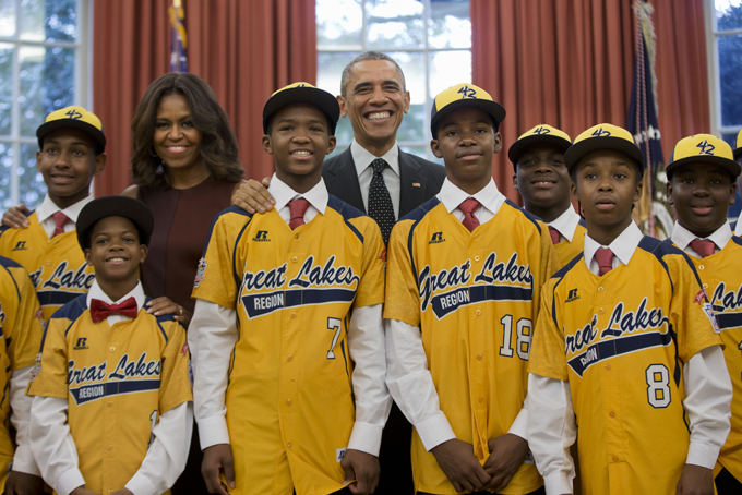 In this Nov. 6, 2014, file photo President Barack Obama and first lady Michelle Obama pose with members of the Jackie Robinson West little league team in the Oval Office of the White House in Washington. (AP Photo/Pablo Martinez Monsivais, File)