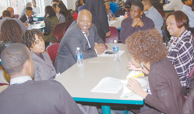 MENTORING THE YOUTH—From left: Husband and wife mentors, Eric Cofield, senior lead at Education Management Corporation, and Bridgette N. Cofield, JD, SPHR, senior vice president and chief talent officer at Chester Group, listen as students share their ambitions 