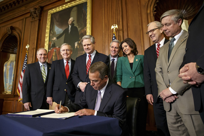 FILE - In this Feb. 13, 2015 file photo, House Speaker John Boehner of Ohio signs the bill authorizing expansion of the Keystone XL pipeline, on Capitol Hill in Washington. Boehner says Congress is sending President Barack Obama legislation to build the Keystone XL pipeline on Tuesday. The White House is indicating Obama will quickly veto it in private over Republican lawmakers' urging that he sign it. It would be the third veto of Obama's presidency. From left are, House Majority Whip Steve Scalise of La., Senate Majority Leader Mitch McConnell of Ky., Sen. John Hoeven, R-N.D., Senate sponsor of the Keystone XL pipeline bill, Boehner, House Majority Leader Kevin McCarthy of Calif., Rep. Kristi Noem, R-S.D., Rep. Kevin Cramer, R-N.D., and House Energy and Commerce Committee Chairman Rep. Fred Upton, R-Mich. (AP Photo/J. Scott Applewhite, File)