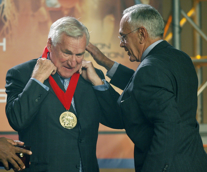 In a Nov. 19, 2006, file photo, Larry Brown, right, presents former North Carolina head basketball coach, Dean Smith, with a medal during Smith's induction into the National Collegiate Basketball Hall of Fame in Kansas City, Mo. Smith, the North Carolina basketball coaching great who won two national championships, died "peacefully" at his home Saturday night, Feb. 7, 2015, the school said in a statement Sunday from Smith's family. He was 83. (AP Photo/Ed Zurga, File)