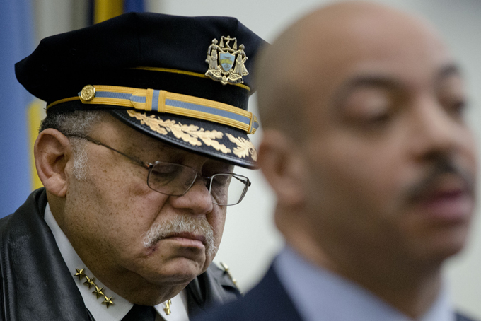 Philadelphia Police Commissioner Charles Ramsey, left, listens as District Attorney Seth Williams speaks during a news conference, Thursday, Feb. 5, 2015, in Philadelphia. Two Philadelphia police officers face brutality charges after prosecutors say they knocked a man off a scooter and beat him so severely another officer thought the bloodied man had been shot. (AP Photo/Matt Rourke)