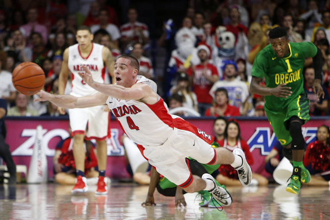 Arizona guard T.J. McConnell (4) makes a pass during the second half of an NCAA college basketball game against Oregon, Wednesday, Jan. 28, 2015, in Tucson, Ariz. Arizona won 90-56. (AP Photo/Rick Scuteri)