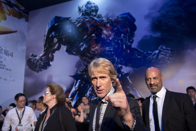 In this June 23, 2014 file photo, director Michael Bay, center, gestures to fans as he attends the premiere of movie "Transformers: Age of Extinction" at a theatre in Beijing, China. The movie is nominated for a Razzie award. The 35th annual Golden Raspberry (RAZZIE) Awards, ceremonies are held on Saturday, Feb. 21, 2015, at the Montalban Theatre in Los Angeles. (AP Photo/Alexander F. Yuan, File)