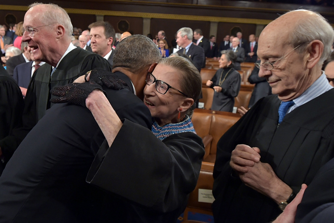 President Barack Obama embraces Supreme Court Justice Ruth Bader Ginsburg as Supreme Court Justices Anthony M. Kennedy (L) and Stephen G. Breyer look on before the President's State Of The Union address on Tuesday, Jan. 20, 2015, on Capitol Hill in Washington. (AP Photo/Mandel Ngan, Pool)