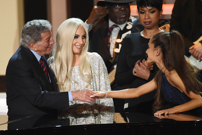 Tony Bennett, far left, shakes hands with singer Ariana Grande as Lady Gaga, second from left, and Jennifer Hudson, second from right, look on during the finale of "Stevie Wonder: Songs in the Key of Life - An All-Star Grammy Salute," at the Nokia Theatre L.A. Live on Tuesday, Feb. 10, 2015, in Los Angeles. (Photo by Chris Pizzello/Invision/AP)