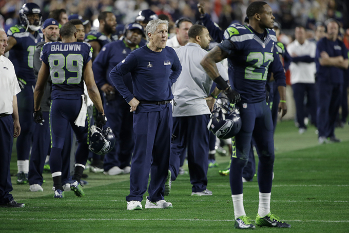Seattle Seahawks head coach Pete Carroll, center, watches as players react after Russell Wilson was intercepted by New England Patriots strong safety Malcolm Butler during the second half of NFL Super Bowl XLIX football game Sunday, Feb. 1, 2015, in Glendale, Ariz. (AP Photo/Matt Rourke)