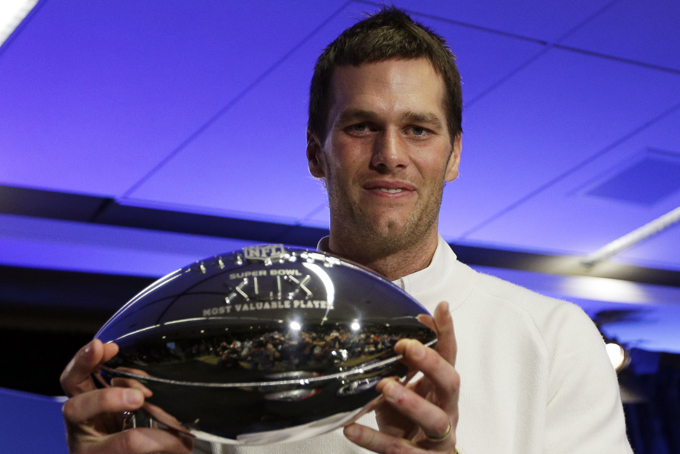 New England Patriots quarterback Tom Brady holds up his Pete Rozelle Trophy during a news conference after the NFL Super Bowl XLIX football game Monday, Feb. 2, 2015, in Phoenix, Ariz. The Patriots beat the Seattle Seahawks  28-24. Brady was named the games most valuable player. (AP Photo/David J. Phillip)