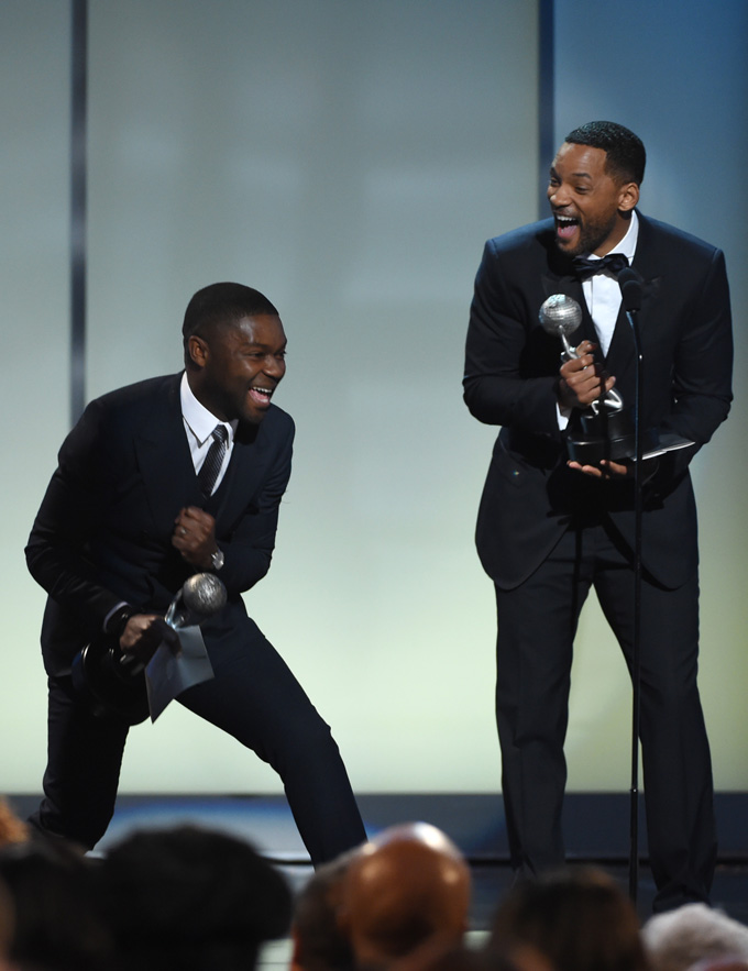 Will Smith, left,  presents David Oyelowo, with the award for outstanding motion picture for "Selma" on stage at the 46th NAACP Image Awards at the Pasadena Civic Auditorium on Friday, Feb. 6, 2015, in Pasadena, Calif. (Photo by Chris Pizzello/Invision/AP)