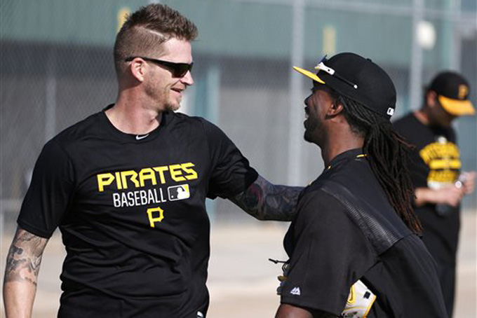 Pittsburgh Pirates' Andrew McCutchen, right, is greeted by pitcher A.J. Burnett as he arrives to take part in an informal spring training baseball workout in Bradenton, Fla., Tuesday, Feb. 17, 2015. Pirates pitchers and catchers officially start the spring on Thursday, Feb. 19. (AP Photo/Gene J. Puskar)