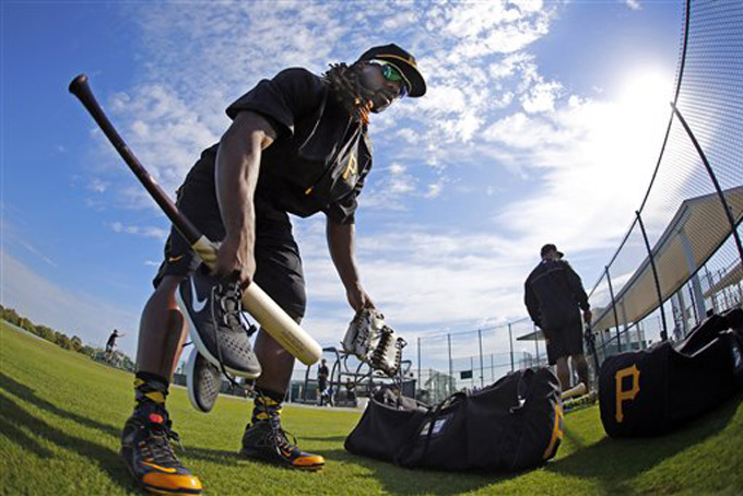 In this photo taken with a fisheye lens Pittsburgh Pirates' Andrew McCutchen gathers his equipment during an informal spring training workout in Bradenton, Fla., Tuesday, Feb. 17, 2015. Workouts officially get underway for Pirates pitchers and catchers Thursday, Feb. 19, with the full squad taking the field on Tuesday, Feb. 24. (AP Photo/Gene J. Puskar)