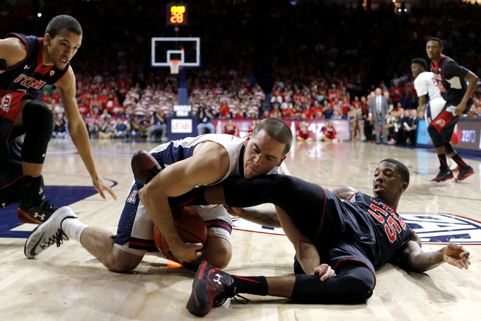 Arizona guard T.J. McConnell, center, and Utah guard Delon Wright (55) battle for the ball during the first half of an NCAA college basketball game, Saturday, Jan. 17, 2015, in Tucson, Ariz. (AP Photo/Rick Scuteri)