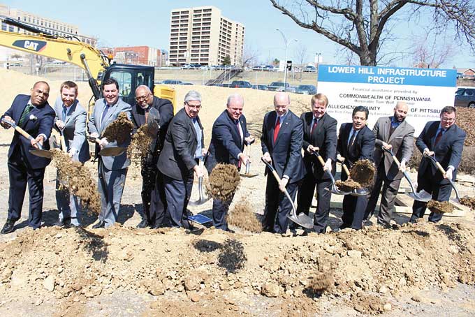 A NEW DAY DAWNS—Federal, state and local partners break ground for the first phase of the $440 million project to redevelop the lower Hill District and to rebuild the Hill and beyond. (Photo by J.L. Martello)
