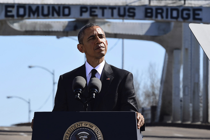President Barack Obama speaks near the Edmund Pettus Bridge, Saturday, March 7, 2015, in Selma, Ala. This weekend marks the 50th anniversary of "Bloody Sunday," a civil rights march in which protestors were beaten, trampled and tear-gassed by police at the Edmund Pettus Bridge, in Selma. (AP Photo/Bill Frakes)