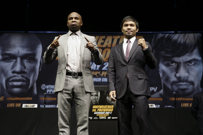 Boxers Floyd Mayweather Jr., left, and Manny Pacquiao, of the Philippines, pose for photos after a news conference, Wednesday, March 11, 2015, in Los Angeles. The two are scheduled to fight in Las Vegas on May 2. (AP Photo/Jae C. Hong)