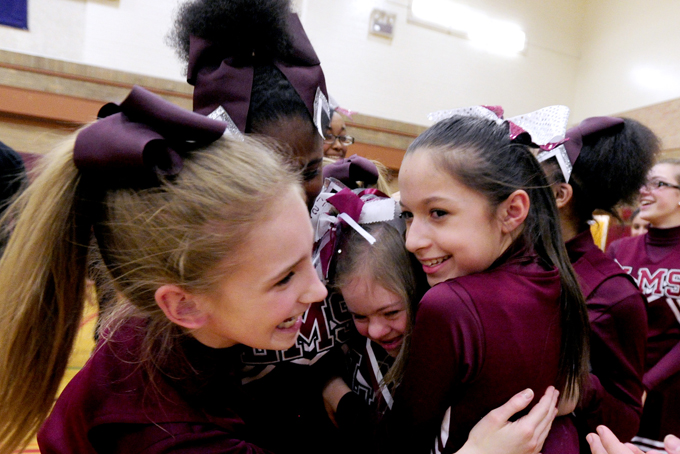 Desiree Andrews, 14, gets a hung from fellow cheerleaders Alyssa Smith, left, and Abby DeNio after a short celebration during which the gymnasium at Lincoln Elementary School was named after her on March 9, 2015 in Kenosha, Wis. (AP Photo/Kenosha News, Kevin Poirier)   