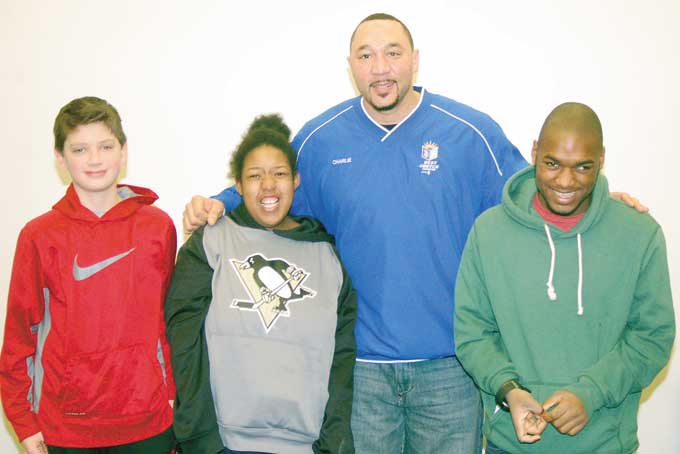 HEALTHY LIVING—Our daily health is always an important priority. So the North Side Public Library, Allegheny General Hospital and Best of The Batch Foundation, teamed up to share Health & Wellness Day. Steelers’ Super Bowl Champion quarterback Charlie Batch stopped by to talk with the community about healthy eating and life after football. Pictured above, from left, are Adam Banzer, 13; Jaymie Edwards, 18; Charlie Batch and Travon Graham Gardner. (Photos by Rossano P. Stewart) 