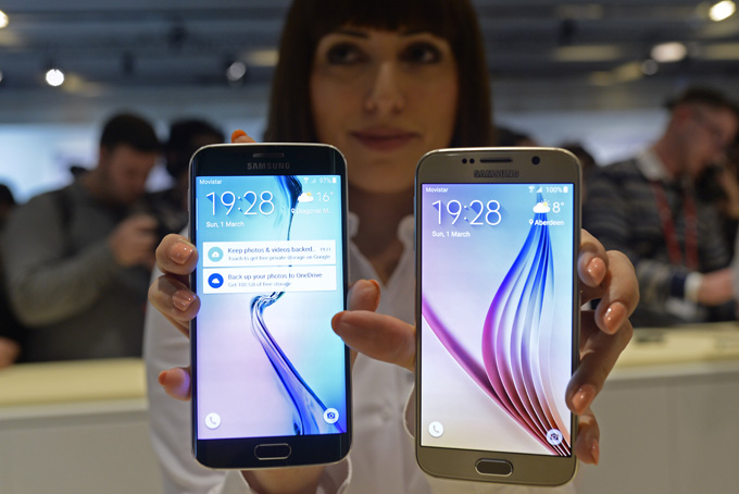 In this March 1, 2015, file photo, the new Galaxy S6, right, and S6 Edge are displayed during a Samsung Galaxy Unpacked 2015 event on the eve of this weeks Mobile World Congress wireless show in Barcelona, Spain. A better design, a better camera and fewer frills make the new Galaxy S6 phones the best Samsung has yet to offer. (AP Photo/Manu Fernandez, File)