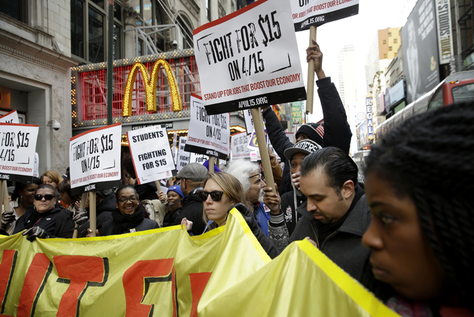 People participate in rally in front of a McDonalds in New York, Tuesday, March 31, 2015. (AP Photo/Seth Wenig)