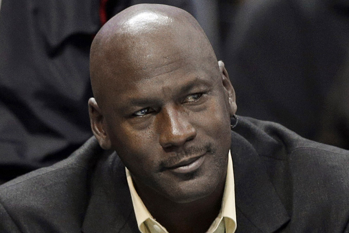 This is an April 16, 2014, file photo showing Charlotte Bobcats owner Michael Jordan watching during the first half of an NBA basketball game between the Bobcats and the Chicago Bulls in Charlotte, N.C. Michael Jordan and two other NBA owners have joined Forbes’ annual list of the world’s billionaires. Forbes said Monday, March 2, 2015, that Jordan’s net worth is estimated at $1 billion, thanks to his well-timed investment in the Charlotte Hornets. (AP Photo/Chuck Burton, File)