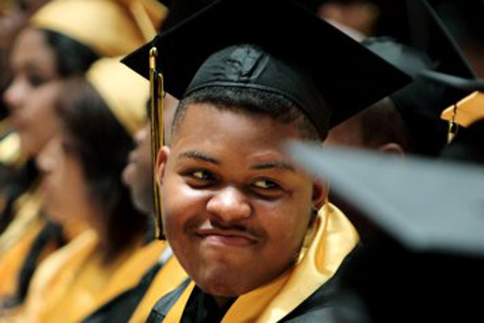 Darreontae Martin laughs with his classmates during the graduation ceremony for Sheffield High School at the Orpheum Theatre in Memphis, Tenn. on Sunday, May 20, 2012. Martin, a former football player at Sheffield who was struck by two drag-racing cars while crossing the street in May 2011, achieved his goal of walking across the stage to get his diploma without the use of a cane. (AP Photo/The Commercial Appeal, Mike Brown)