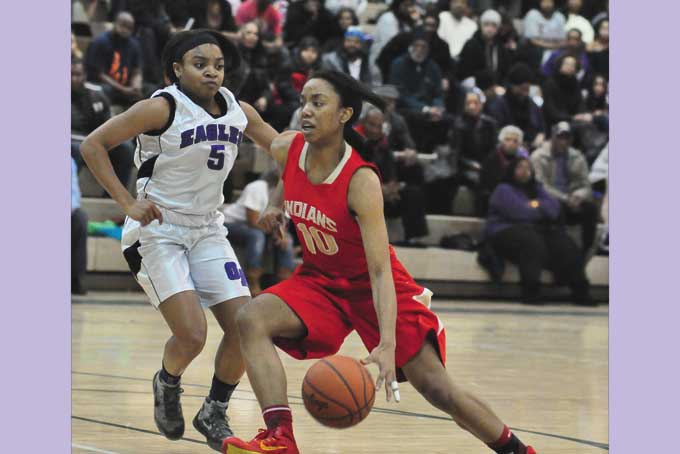 JADE ELY (10) of Penn Hills drives on Kennedy Bowens of Obama Academy. Ely scored 23 points to lead the Indians to a 39-26 win in the PIAA Class AAAA playoffs.