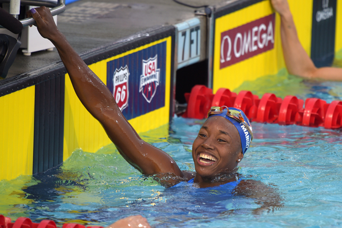 In this Aug. 10, 2014, file photo, Simone Manuel smiles after winning the women's 50-meter freestyle final at the U.S. nationals of swimming in Irvine, Calif. Ryan and Simone Manuel were always close. They still talk just about every day, even though they attend college in different parts of the country. (AP Photo/Mark J. Terrill, File)