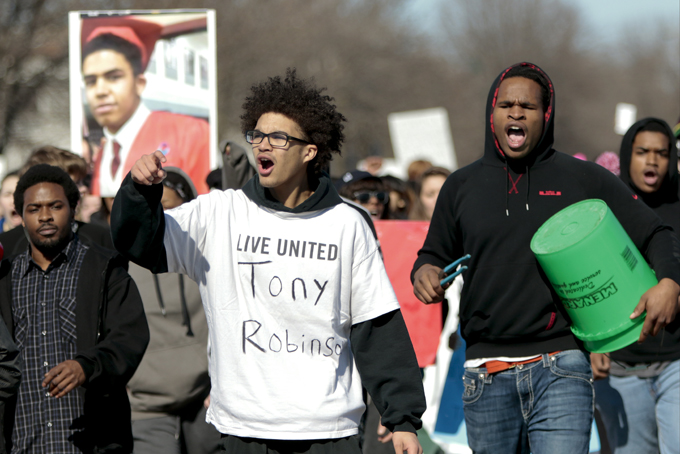 Demonstrators walk down South Ingersoll Street during to protest the shooting of Tony Robinson at the state Capitol Monday, March 9, 2015, in Madison, Wis. Robinson, 19, was fatally shot Friday night by a police officer who forced his way into an apartment after hearing a disturbance while responding to a call. Police say Robinson had attacked the officer. (AP Photo/Wisconsin State Journal, Michael P. King)