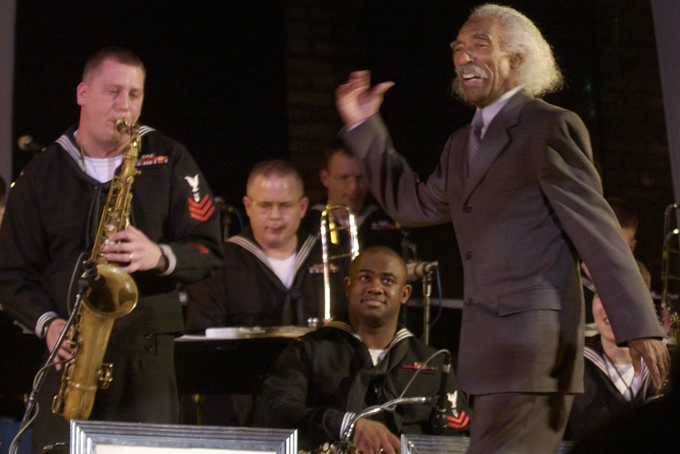 In this Friday, Feb. 28, 2003, file photo, Gerald Wilson, right, a former Navy Band member, conducts the Navy Band Great Lakes Jazz Ensemble as Petty Officer 1st Class Greg Dudzcenski, left, solos during concert at the Great Lakes Naval Training Center in Great Lakes, Ill. The Playboy Jazz Festival will pay tribute to one of Los Angeles' own jazz greats, Gerald Wilson, with son Anthony Wilson leading his late father's big band, at the two-day festival that begins June 13, 2015. (AP Photo/Brian Kersey, File)
