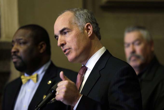 U.S. Sen. Bob Casey, D-Pa., center, accompanied by City Councilman Kenyatta Johnson, left, and Philadelphia Fire Fighters' Union Vice President Timothy McShea, speaks during a news conference, Monday, March 16, 2015, at City Hall in Philadelphia. Casey and Philadelphia emergency responders are calling for legislation to provide new resources and training to first responders dealing with oil train derailments. A proposed bill would create a special derailment task force to craft training recommendations. (AP Photo/Matt Rourke)