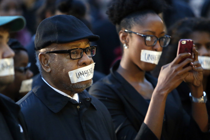 George Henderson, left, professor emeritus, joins students at the University of Oklahoma to protest a fraternity's racist comments on March 9, 2015 in Norman, Okla. (AP Photo/The Oklahoman, Steve Sisney)
