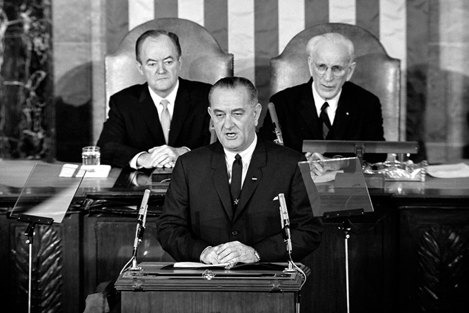 FILE - In this March 15, 1965 file photo, U.S. President Lyndon B. Johnson addresses a joint session of Congress in Washington where he urged the passing of the Voting Rights Act and spoke of his experience as a young teacher in a segregated, Mexican-American school. Vice President Hubert Humphrey is at left and House Speaker John McCormack is at right. (AP Photo/File)
