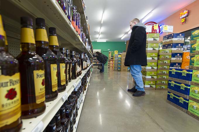 Amanda Phillips, left, and Brendon Joyce shop for alcohol at a 21st Amendment liquor store in Carmel, Ind., Thursday, Feb. 19, 2015. Indiana will keep the distinction of being the last state with a "blue law" banning Sunday carry-out alcohol sales after the sponsor of a bill that would have lifted the ban said Tuesday, 24 the measure is dead. (AP Photo/Doug McSchooler)